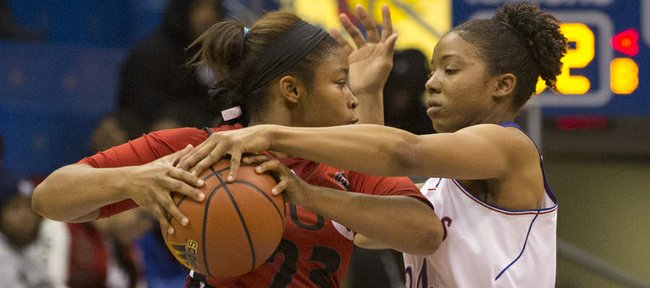 Kansas' CeCe Harper (24) gets a hand on the ball while pressuring Southern Illinois-Edwardsville's Alexis Chappelle (23) during their game Wednesday at Allen Fieldhouse.