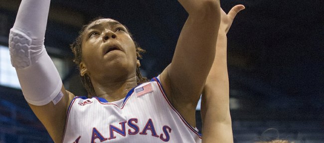Kansas' Asia Boyd (0) creates contact as she shoots over Oral Roberts' Noora Jaervikangas (24) during their game Sunday afternoon at Allen Fieldhouse. The Jayhawks won their season opener, 84-62.