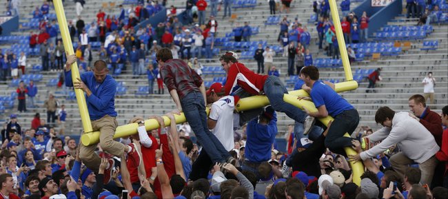 Kansas fans bring down the south goal post following the Jayhawks' 31-19 win over West Virginia on Saturday, Nov. 16, 2013 at Memorial Stadium.