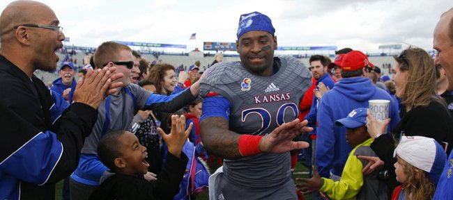 Kansas running back James Sims runs off the field to the hearty applause of Jayhawk fans following the Jayhawks' 31-19 win over West Virginia on Saturday, Nov. 16, 2013 at Memorial Stadium.