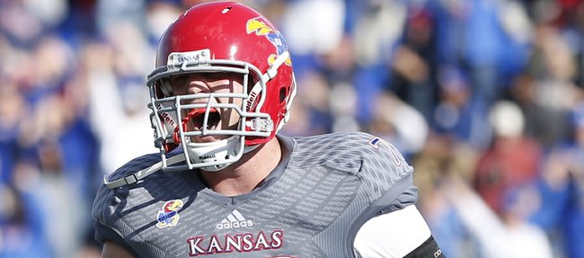 Kansas offensive lineman Riley Spencer celebrates a touchdown by running back James Sims against West Virginia during the third quarter on Saturday, Nov. 16, 2013 at Memorial Stadium.