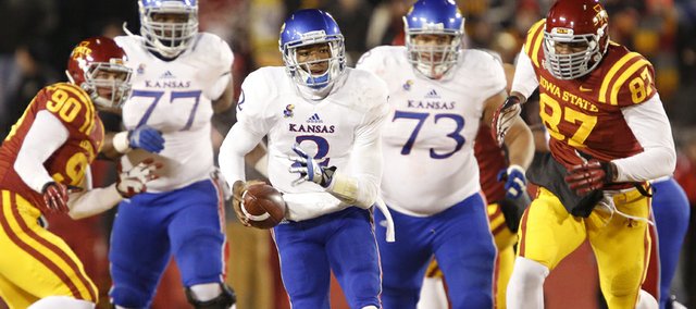 Kansas quarterback Montell Cozart takes off on a run against the Iowa State defense during the second quarter on Saturday, Nov. 23, 2013 at Jack Trice Stadium in Ames, Iowa.