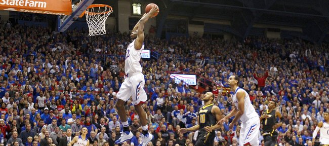 Thousands watch as Kansas guard Andrew Wiggins soars in for a jam on a breakaway against Towson during the first half on Friday, Nov. 22, 2013 at Allen Fieldhouse.