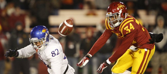 Kansas receiver Andrew Turzilli is tossed to the ground by Iowa State defensive back Nigel Tribune after bobbling a pass during the fourth quarter on Saturday, Nov. 23, 2013 at Jack Trice Stadium in Ames, Iowa.