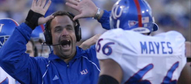 Kansas offensive line coach John Reagan looks to high five lineman Adrian Mayes following a Jake Sharp touchdown during the second half against the Buffaloes, Saturday, Oct. 20, 2007 at Folsom Field in Boulder.