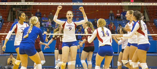 Kansas' Caroline Jarmoc (9) pumps her fist in the air after making a kill during Kansas' volleyball match against Denver Tuesday evening at Allen Fieldhouse. The Jayhawks won the match, 3-1.