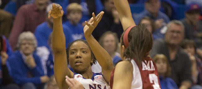 Kansas guard CeCe Harper launches a three past the out-stretched arm of Arkansas defender McKenzie Adams (3) during their game Wednesday night at Allen Fieldhouse.