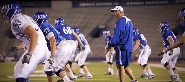 Offensive line coach Tim Grunhard works with his players during a morning practice on Thursday, April 19, 2012 at Memorial Stadium.