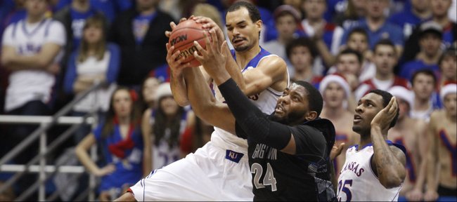 Kansas forward Perry Ellis competes for a rebound with Georgetown center Josh Smith and teammate Tarik Black during the first half on Saturday, Dec. 21, 2013 at Allen Fieldhouse.
