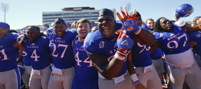 Kansas defensive lineman Keon Stowers hams it up for the cameras as the Jayhawks celebrate their 13-10 win over Louisiana Tech on a walk-off fieldgoal from kicker Matthew Wyman, Saturday, Sept. 21, 2013 at Memorial Stadium.