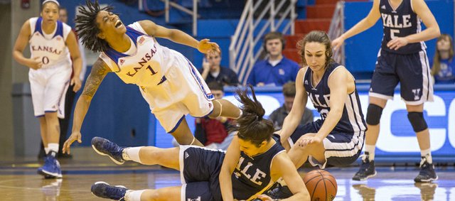 Kansas sophomore guard Lamaria Cole (1) falls as she is undercut by Yale's Sarah Halejian as they scramble for a loose ball along with Hayden Latham, right, during their game, Sunday, Dec. 29, 2013, at Allen Fieldhouse.
