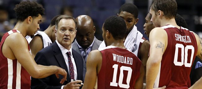 Oklahoma head coach Lon Kruger talks to his team during a timeout in the second half of an NCAA college basketball game in the BB&T Classic against George Mason, Sunday, Dec. 8, 2013, in Washington. Oklahoma won 81-66. (AP Photo/Alex Brandon)