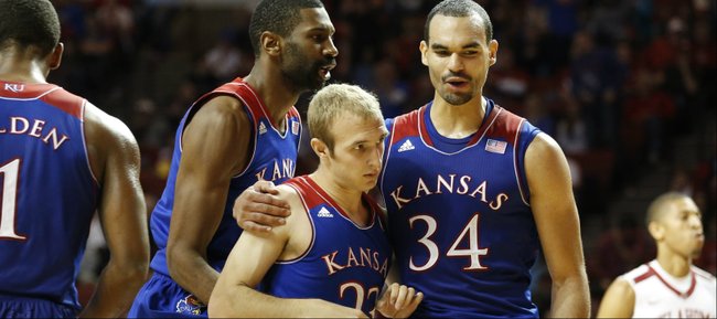 Kansas forwards Perry Ellis (34) and Justin Wesley celebrate a late three by Kansas guard Conner Frankamp (23) against Oklahoma during the first half on Wednesday, Jan. 8, 2013 at Lloyd Noble Center in Norman, Oklahoma.