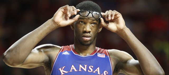 Kansas center Joel Embiid adjusts his protective eyewear in the second half on Wednesday, Jan. 8, 2013 at Lloyd Noble Center in Norman, Oklahoma.