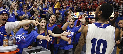 Kansas guard Naadir Tharpe holds his hand up to his ear to better hear the roar of the fieldhouse as he leaves the floor following the Jayhawks' 80-78 win over Oklahoma State on Saturday, Jan. 18, 2014 at Allen Fieldhouse.
