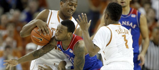 Kansas guard Naadir Tharpe misses going for a steal from Texas forward Jonathan Holmes during the first half on Saturday, Feb. 1, 2014 at Erwin Center in Austin, Texas. Also pictured is Texas guard Isaiah Taylor.