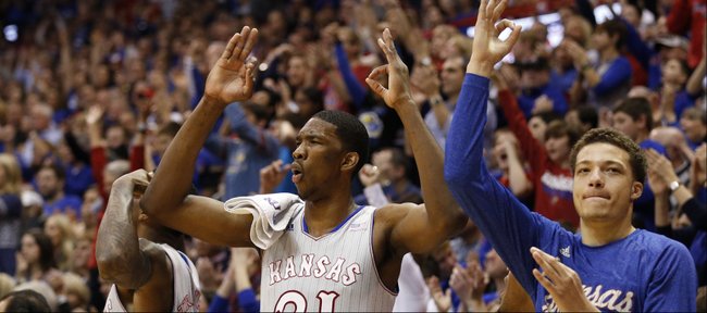 Kansas players Jamari Traylor, left, Joel Embiid, center, and Brannen Greene celebrate a three from teammate Wayne Selden against West Virginia during the second half on Saturday, Feb. 8, 2014 at Allen Fieldhouse.