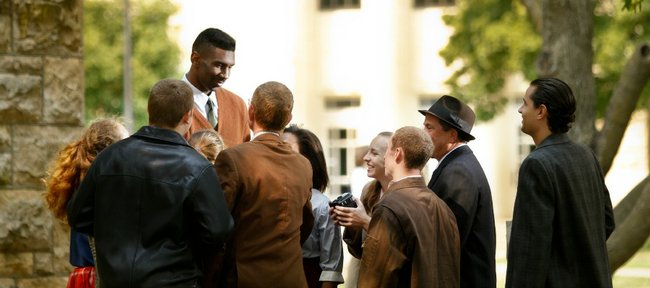During a scene from the first day of the filming of "Jayhawkers," outside the School of Architecture, Kansas forward Justin Wesley, playing the part of Wilt Chamberlain, is greeted by various students and faculty upon his arrival at KU. Jayhawkers is a film by Kansas University film professor Kevin Willmott, which focuses on the emergence of Wilt Chamberlain into college basketball.