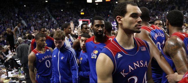 Kansas forward Perry Ellis (34) and his teammates are led off the court as the Kansas State student section celebrates following the Jayhawks' 85-82 overtime loss to Kansas State on Monday, Feb. 10, 2014 at Bramlage Coliseum.
