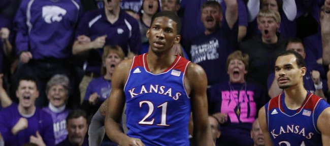 Kansas State forward Thomas Gipson comes down from a dunk before Kansas players Joel Embiid, left, Perry Ellis and Wayne Selden during the second half on Monday, Feb. 10, 2014 at Bramlage Coliseum.