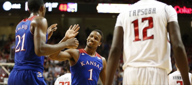 Kansas guard Wayne Selden slaps hands with center Joel Embiid after Embiid drew a Texas Tech foul during the second half on Tuesday, Feb. 18, 2014 at United Spirit Arena in Lubbock, Texas.