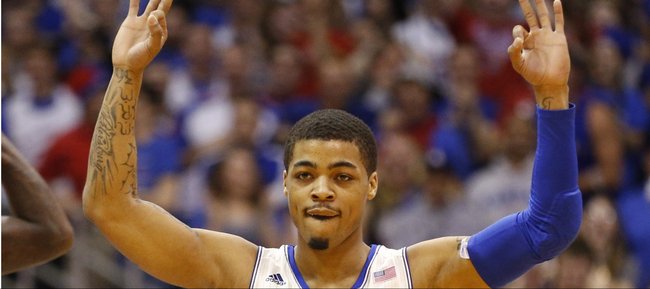 Kansas guard Frank Mason signals "three" after a three-pointer by teammate Andrew Wiggins during the first half on Saturday, Feb. 22, 2014 at Allen Fieldhouse.