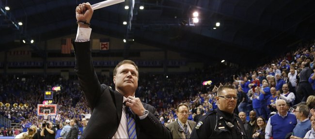 Kansas head coach Bill Self raises a fist to the student section as they salute the the Jayhawks' tenth-straight conference title following their 83-75 win over Oklahoma on Monday, Feb. 24, 2014 at Allen Fieldhouse.