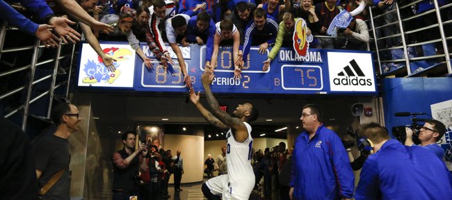 Kansas guard Naadir Tharpe slaps hands with students as he exits the court following the the Jayhawks' 83-75 win over Oklahoma on Monday, Feb. 24, 2014 at Allen Fieldhouse. The win secured a share of a tenth-straight conference title for the Jayhawks.