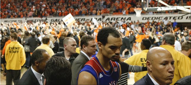 Kansas forward Perry Ellis makes his way to the locker room as Oklahoma State students storm the court following the Cowboys' 72-65 win on Saturday, March 1, 2014 at Gallagher-Iba Arena in Stillwater, Oklahoma.