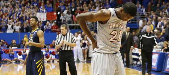 Kansas center Joel Embiid holds his lower back after injuring it during the second half of the Jayhawks' Feb. 8, 2014 game against West Virginia at Allen Fieldhouse.