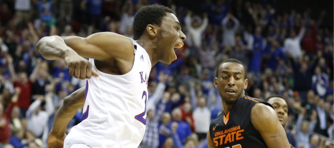 Kansas guard Andrew Wiggins celebrates after a lob dunk before Oklahoma State guard Markel Brown during the second half on Thursday, March 13, 2014 at Sprint Center in Kansas City, Missouri.