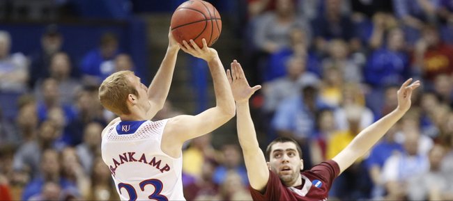 Kansas guard Conner Frankamp pulls up for a shot over Eastern Kentucky guard Isaac McGlone during the first half on Friday, March 21, 2014 at Scottrade Center in St. Louis.