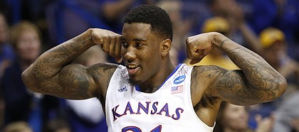 Kansas forward Jamari Traylor flexes after a dunk by teammate Tarik Black against Eastern Kentucky during the second half on Friday, March 21, 2014 at Scottrade Center in St. Louis.