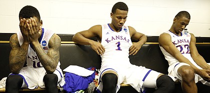 Kansas players Naadir Tharpe, left, Wayne Selden and Andrew Wiggins hang their heads in the locker room following the Jayhawks' 60-57 loss to Stanford on Sunday, March 23, 2014 at Scottrade Center in St. Louis.