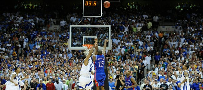 Kansas guard Mario Chalmers hoists a three-pointer over Memphis guard Derek Rose with seconds remaining in the second half of the national championship Monday, April 7, 2008, at the Alamodome in San Antonio.