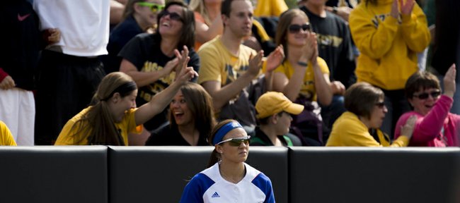 Kansas University’s Taylor Hatfield (10) returns from the outfield wall after failing to catch a home run hit by Missouri’s Kirsten Mack during their NCAA regional softball game, Saturday, May 17, 2014, at University Field in Columbia, Mo.