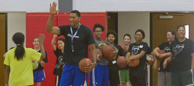 Former NBA player and KU basketball star Wayne Simien leads participants in his Called to Greatness girls basketball camp Thursday, July 3, 2014, at Lawrence High. Simien will hold a boys camp July 8-10.