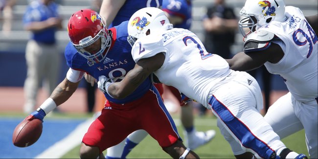 Blue Team receiver Nick Harwell is tackled for a loss by White Team defenders Marcus Jenkins-Moore and Tyler Holmes during the first half of the Kansas Spring Game on Saturday, April 12, 2014 at Memorial Stadium. Nick Krug/Journal-World Photo