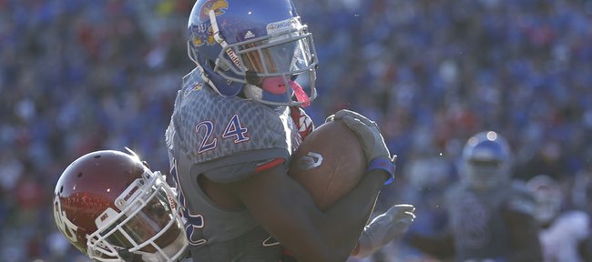 Kansas cornerback JaCorey Shepherd is pulled down by Oklahoma receiver Sterling Shepard following his interception of OU quarterback Blake Bell during the third quarter on Saturday, Oct. 19, 2013 at Memorial Stadium.
