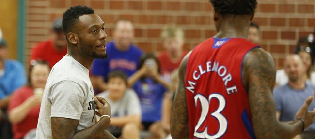 Former Jayhawk Naadir Tharpe, who was on hand for the event, talks dunk strategy with Ben McLemore during the Sir McLemore Summer Slam at the Community Building on Saturday, July 26, 2014.