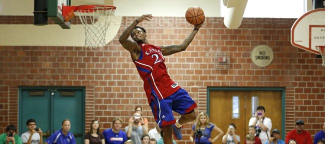 Former Kansas standout Ben McLemore gets airborne for a dunk before fans gathered for the Sir McLemore Summer Slam at the Community Building on Saturday, July 26, 2014. Proceeds from McLemore's charity event will go to fight childhood hunger. 