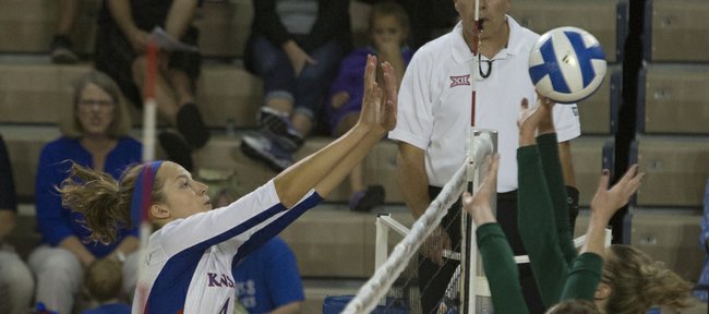 KU senior Sara McClinton (4) gets up for a block against the Utah Valley defense in a volleyball match on Friday August 29, 2014, at Horejsi Center.