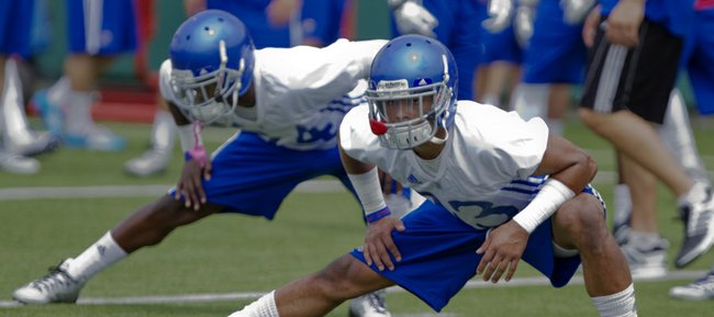 KU safety Cassius Sendish stretches out during the first KU football practice Friday, Aug. 8, 2014, on the football practice fields south of Memorial Stadium.