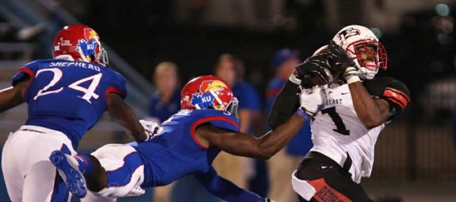 Southeast Missouri State receiver Paul McRoberts pulls in a late fourth-quarter touchdown pass while defended by Kansas players JaCorey Shepherd and Isaiah Johnson on Saturday, Sept. 6, 2014 at Memorial Stadium.