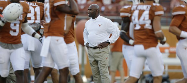 Texas coach Charlie Strong, center, watches the Longhorns prepare for their season opener, Aug. 30 against North Texas in Austin, Texas. UT will visit Kansas on Saturday.