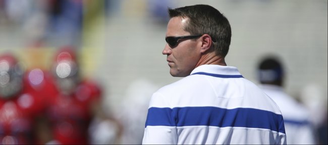 Kansas defensive coordinator Clint Bowen looks out over his defense as the Jayhawks warm up prior to kickoff against Texas on Saturday, Sept. 27, 2014 at Memorial Stadium.