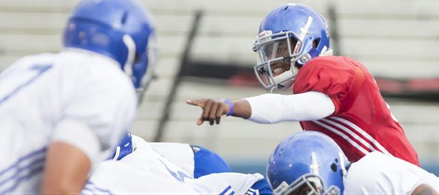 Kansas quarterback Montell Cozart calls out a play during practice on Wednesday, Oct. 1, 2014.
