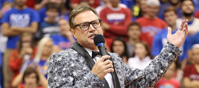 Dressed like number 1 pick Andrew Wiggins from the 2014 NBA Draft, Kansas head basketball coach Bill Self addresses the fieldhouse crowd during Late Night in the Phog on Friday, Oct. 10, 2014.
