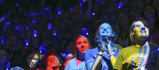 Spotlights shine on Jayhawk fans as they wait with anticipation while the team is introduced during Late Night in the Phog on Friday, Oct. 10, 2014 at Allen Fieldhouse.