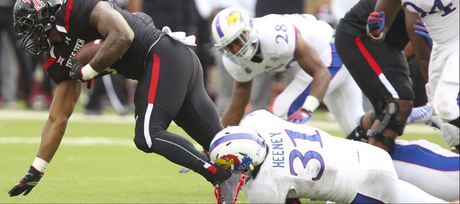 Kansas linebacker Ben Heeney drags down a Texas Tech receiver during the first quarter on Saturday, Oct. 18, 2014 at Jones AT&T Stadium in Lubbock, Texas.